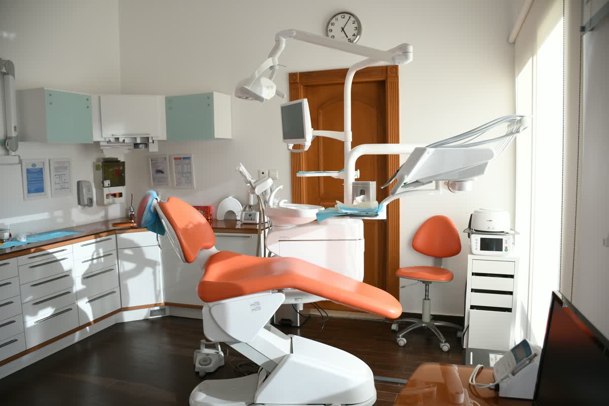 Dentist treating a patient seated in a dental chair